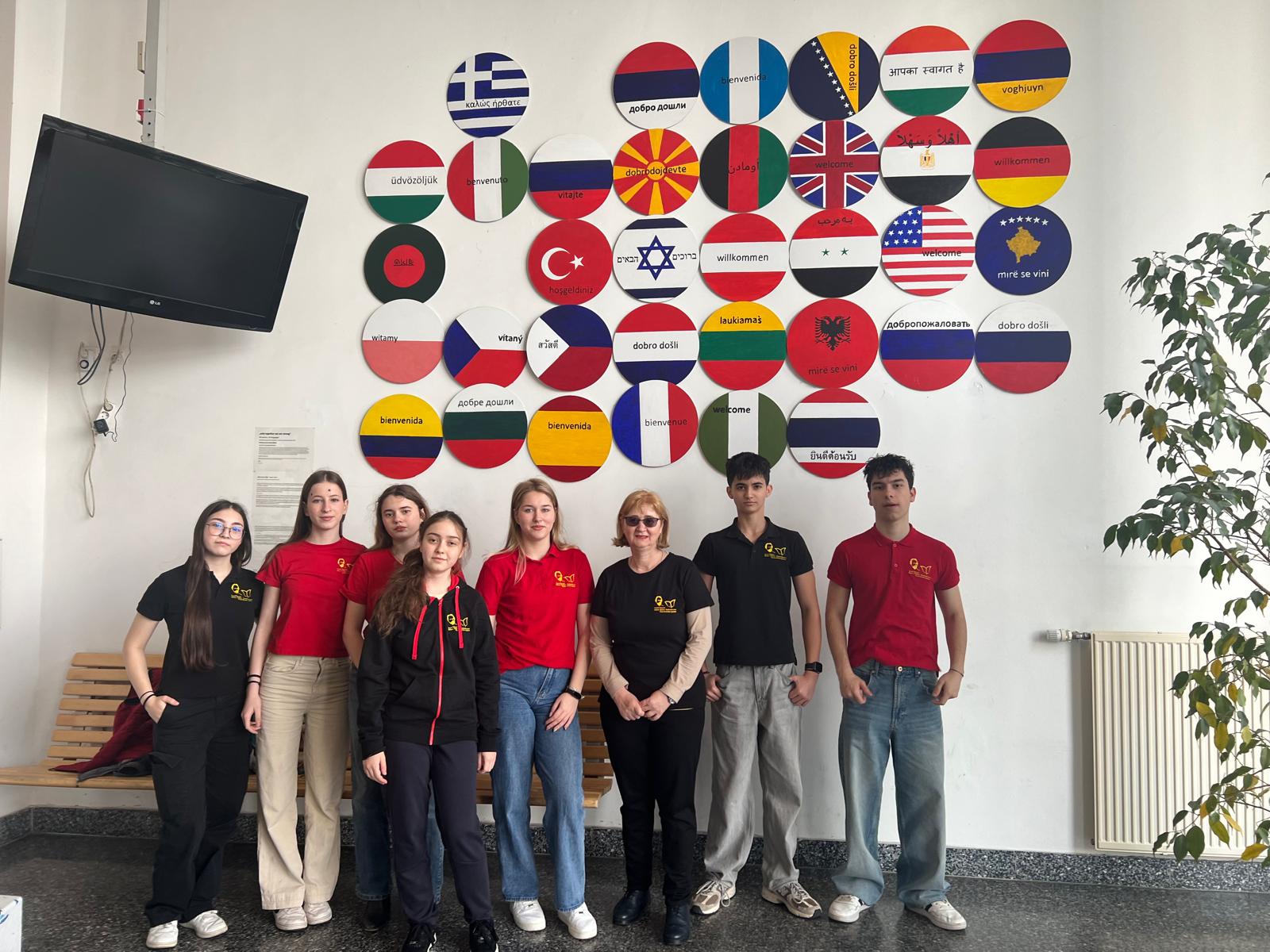 CETI team and international students in front of multilingual welcome wall